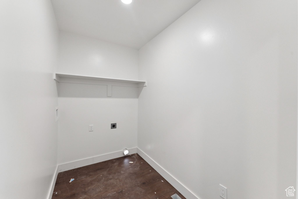 Laundry room with hookup for an electric dryer, baseboards, and dark wood-style flooring