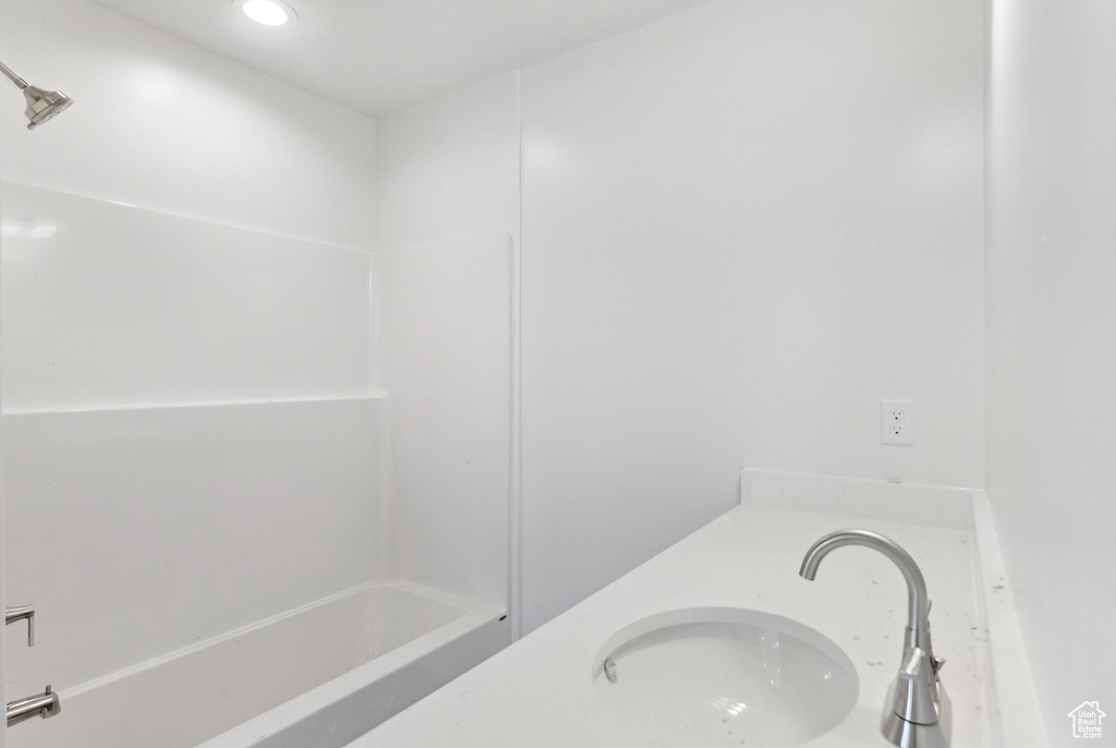 Bathroom with  shower combination, double vanity, and recessed lighting