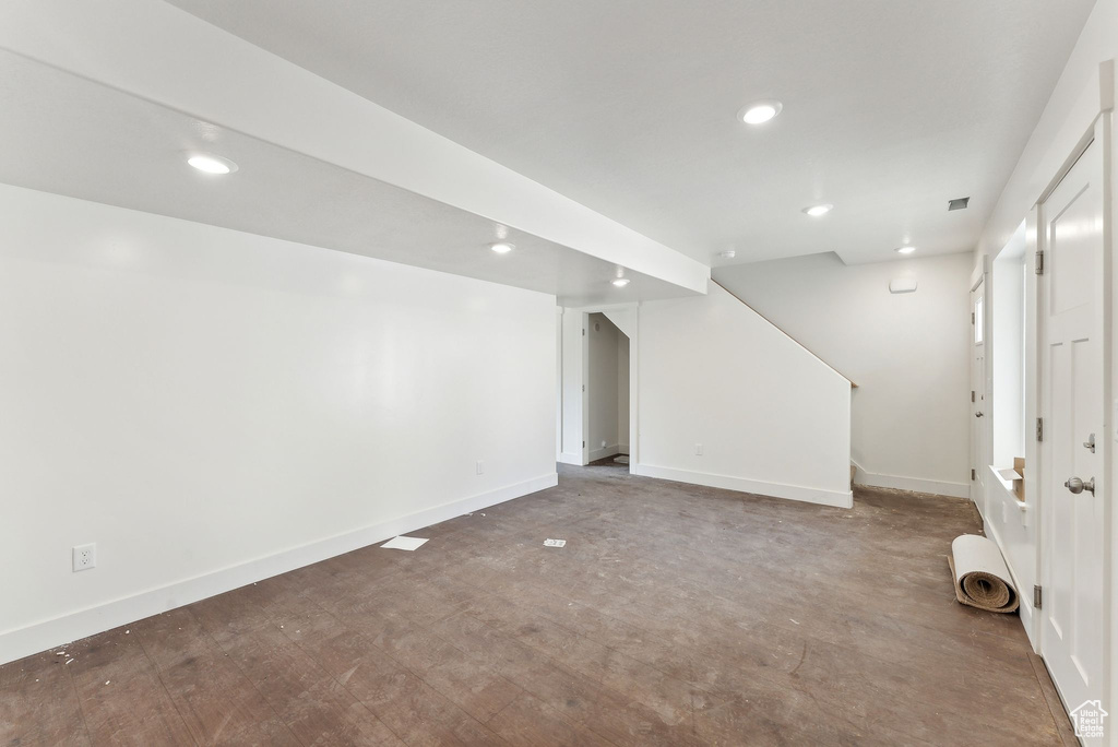 Finished basement with stairway, baseboards, and recessed lighting