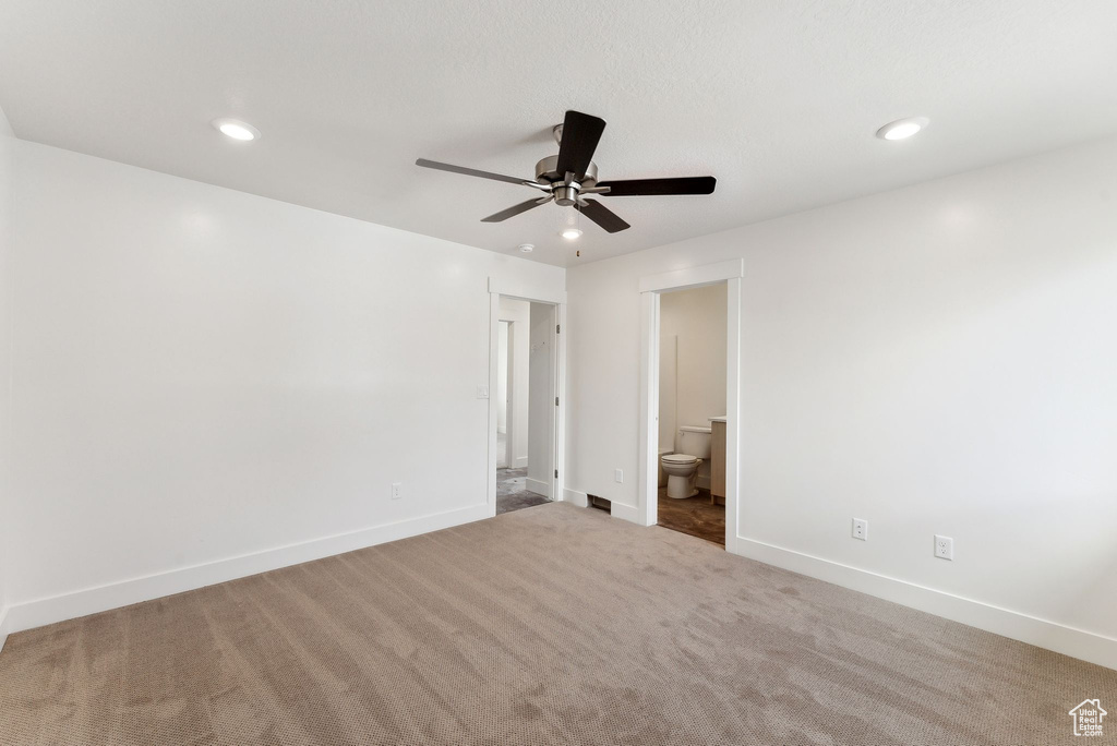 Unfurnished bedroom featuring recessed lighting, carpet floors, baseboards, ensuite bathroom, and ceiling fan