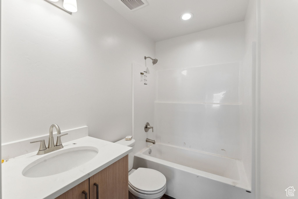 Full bath featuring toilet, vanity, washtub / shower combination, and recessed lighting