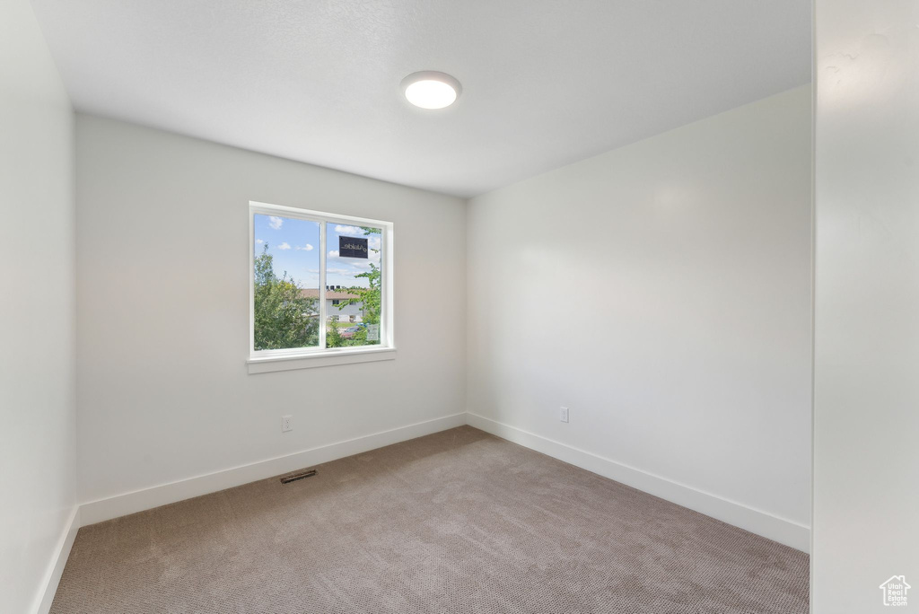 Unfurnished room featuring carpet flooring and baseboards