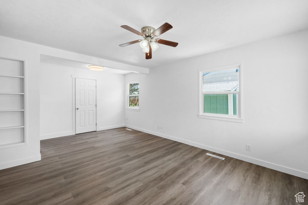 Unfurnished bedroom featuring dark wood-style flooring and ceiling fan