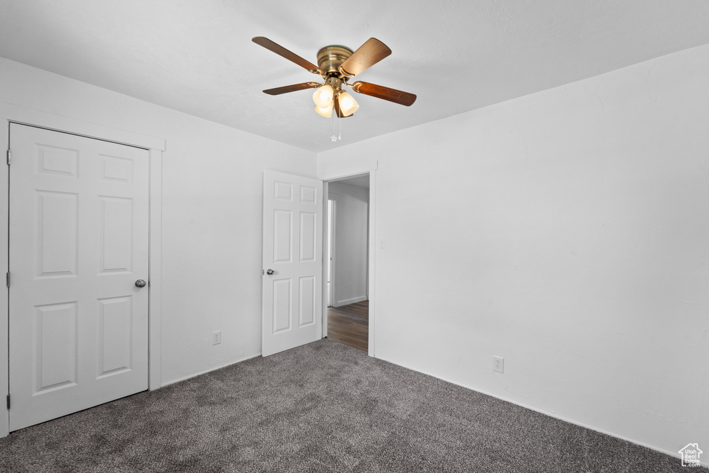 Unfurnished bedroom featuring carpet flooring and ceiling fan