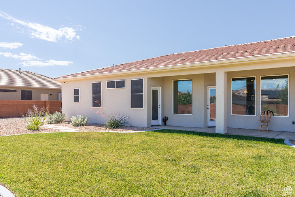 Back of house featuring stucco siding and a patio