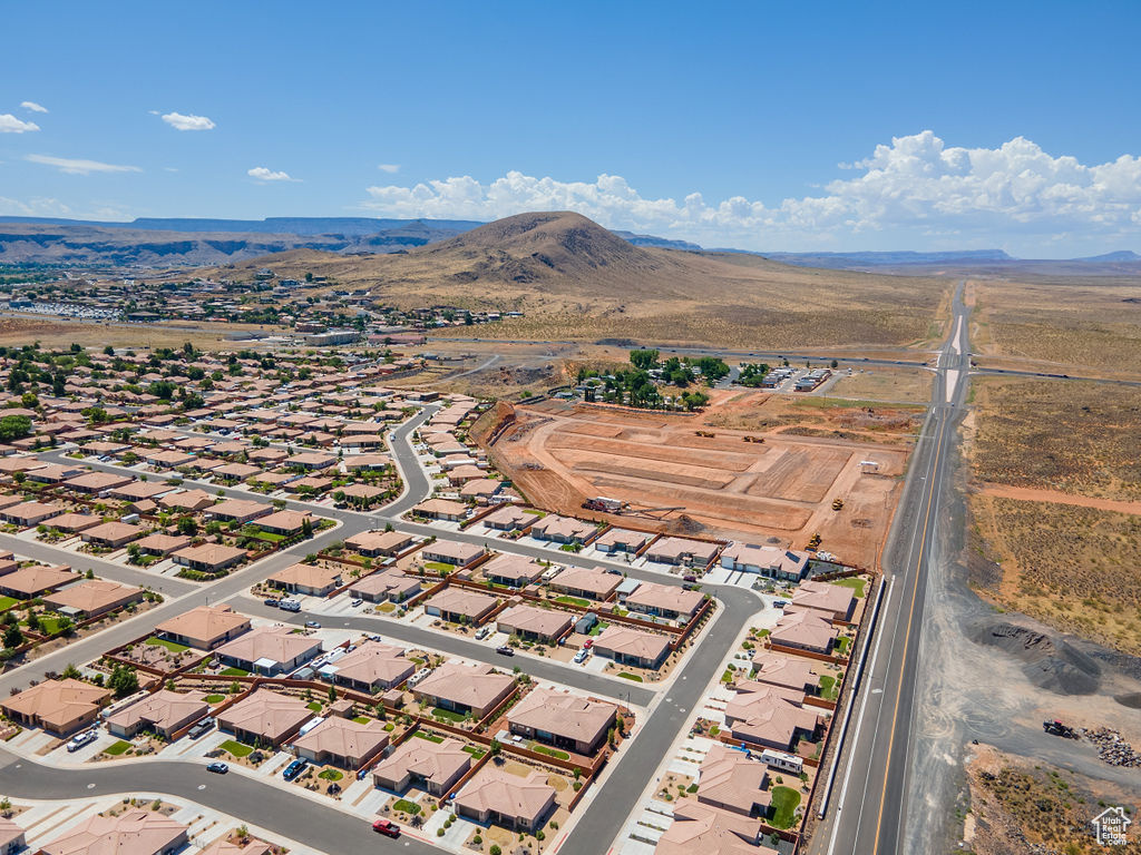 Aerial view of property's location with a mountain backdrop and nearby suburban area