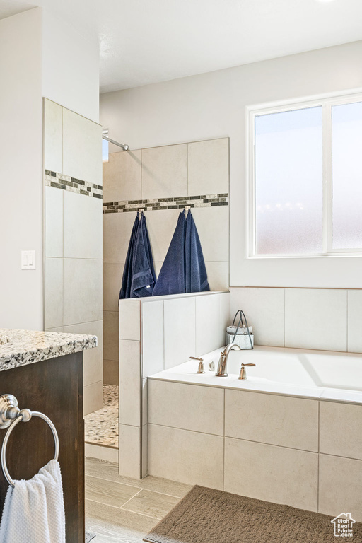 Bathroom with a bath and a walk in shower