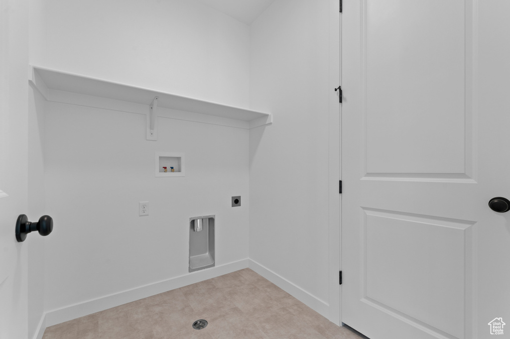 Laundry area featuring hookup for a washing machine, hookup for an electric dryer, and baseboards