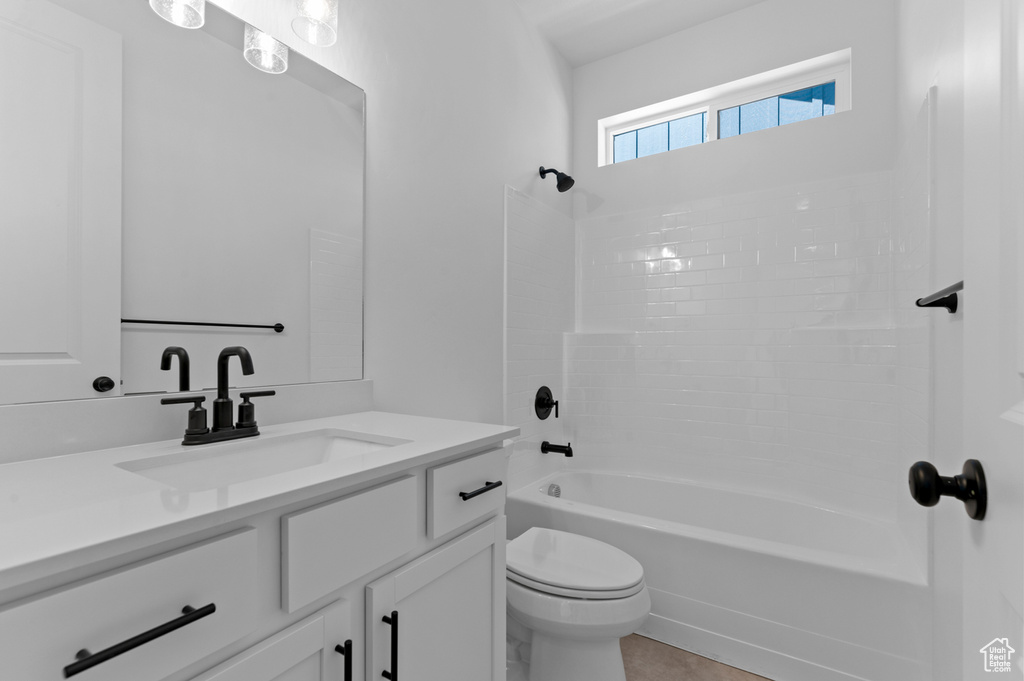 Bathroom with toilet, vanity, and bathtub / shower combination