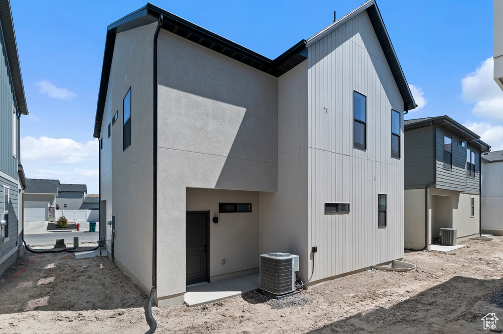 Back of house featuring central AC unit
