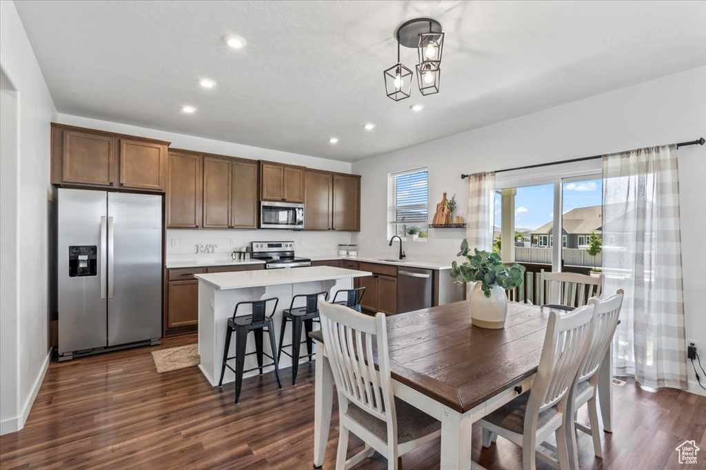 Dining room featuring recessed lighting, dark wood-style flooring, and baseboards