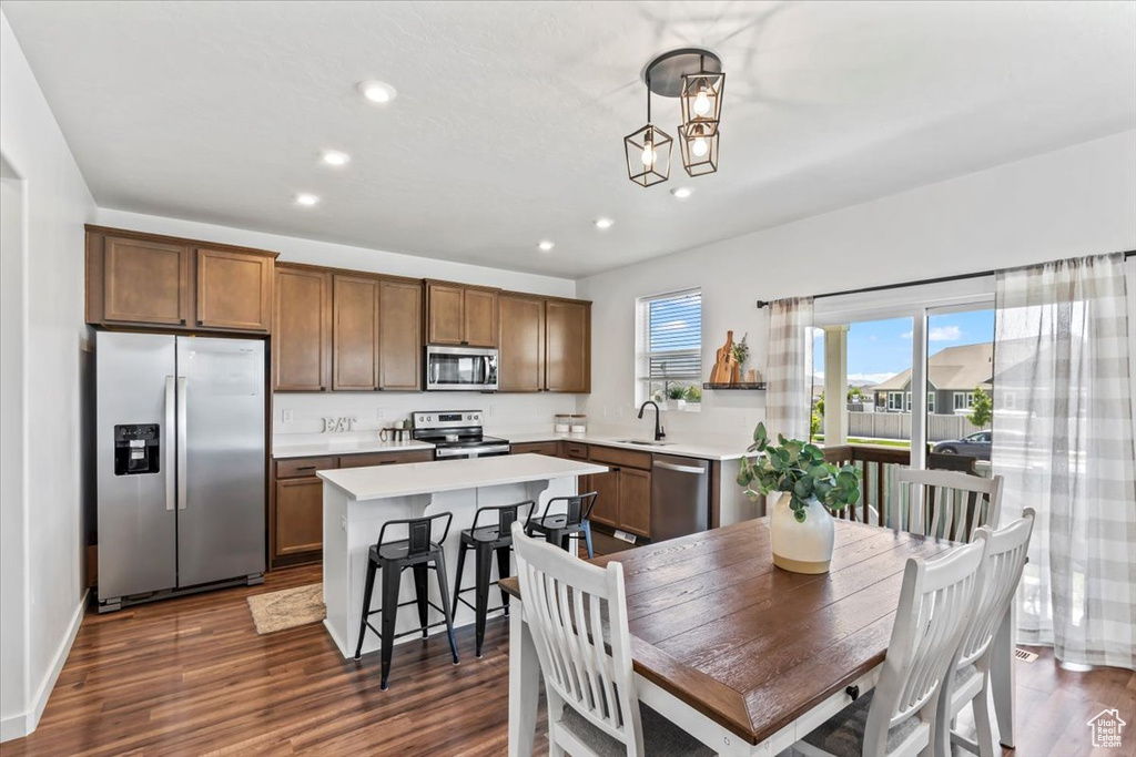 Dining room featuring recessed lighting, dark wood-style flooring, and a chandelier
