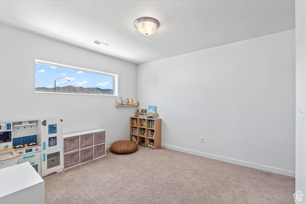 Bedroom featuring light carpet and baseboards