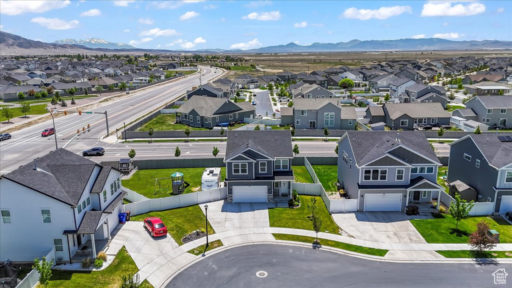 Aerial view of residential area featuring a mountainous background