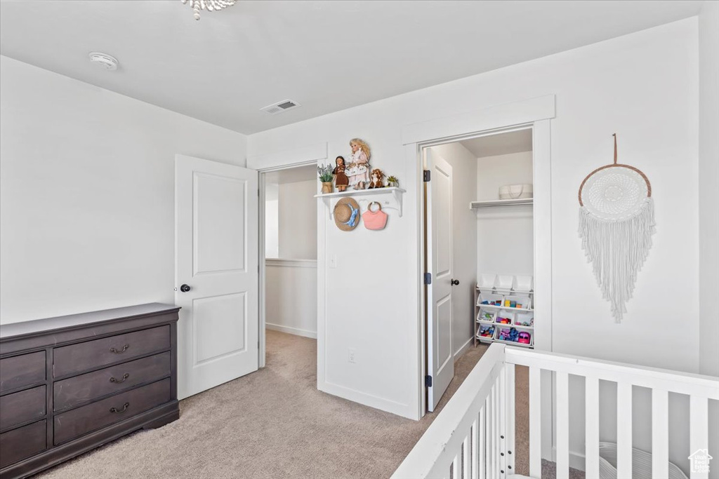 Bedroom featuring light carpet and a closet