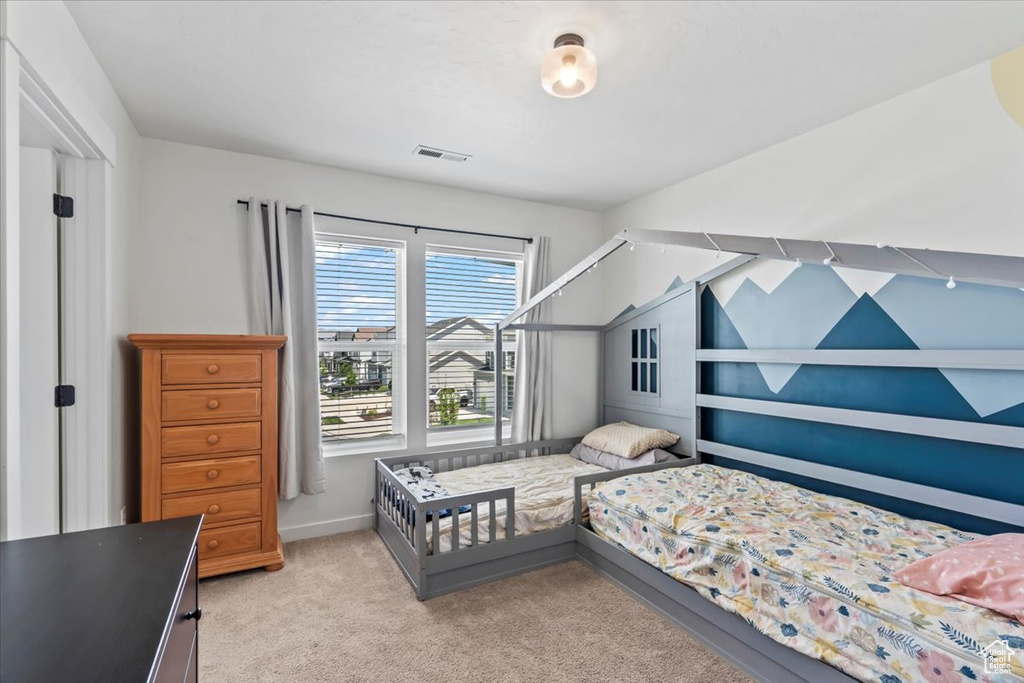 Bedroom with light carpet
