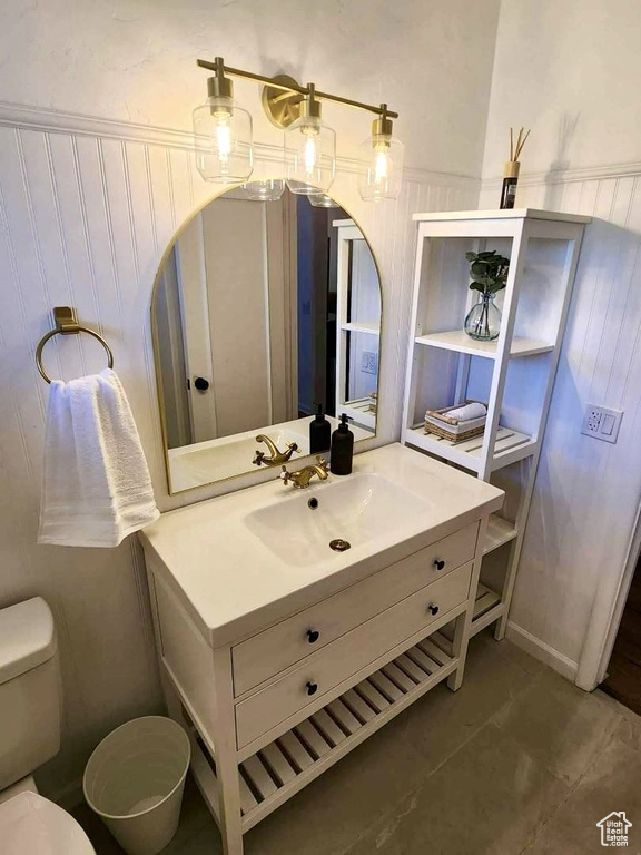 Bathroom featuring vanity, toilet, and tile patterned flooring