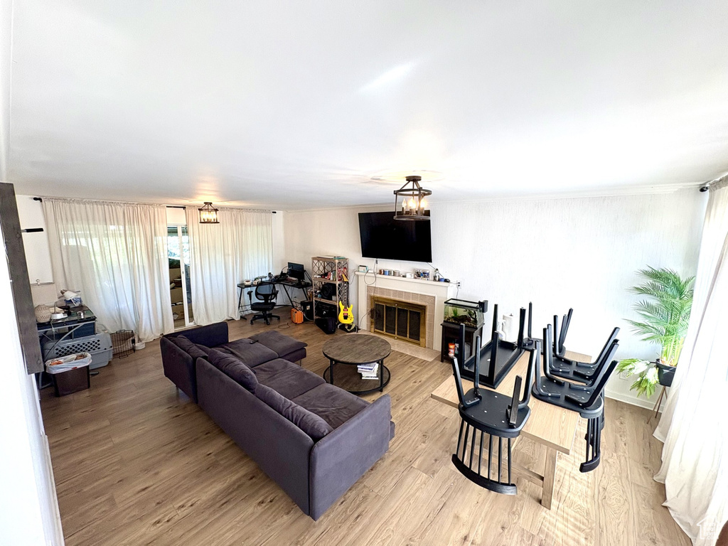 Living area with a tile fireplace and light wood-style floors