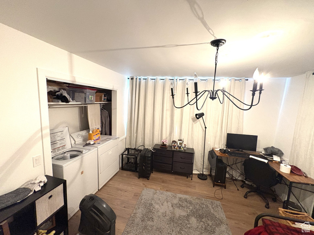 Office with light wood-type flooring and washing machine and clothes dryer