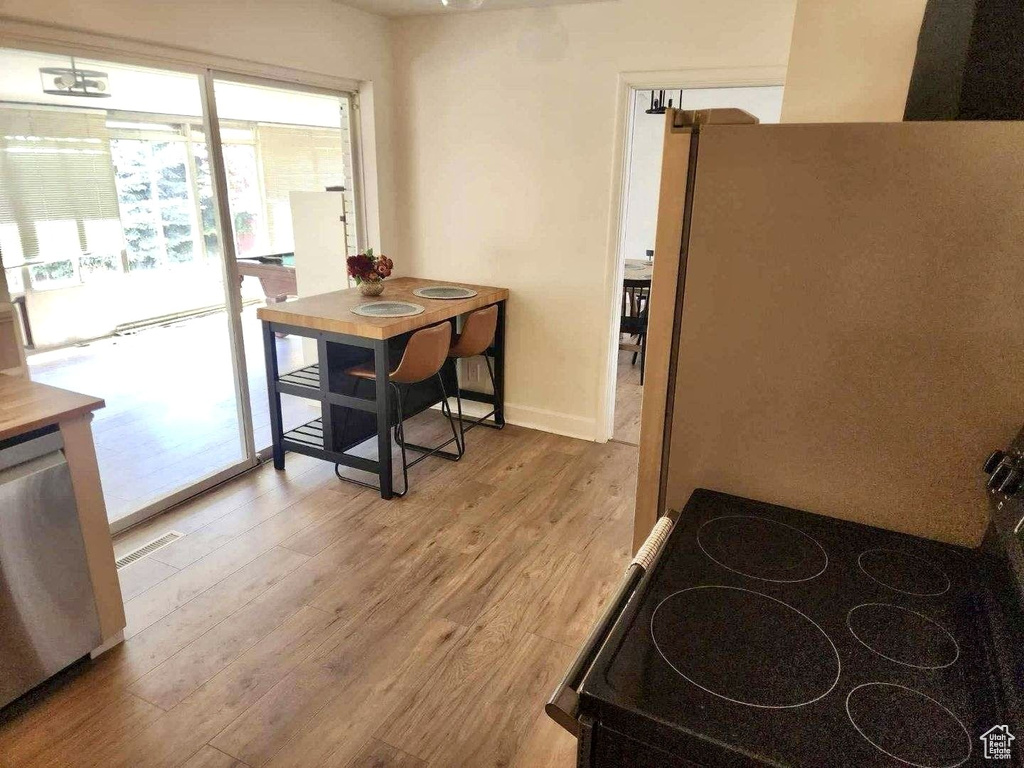 Dining space with light wood-type flooring and baseboards