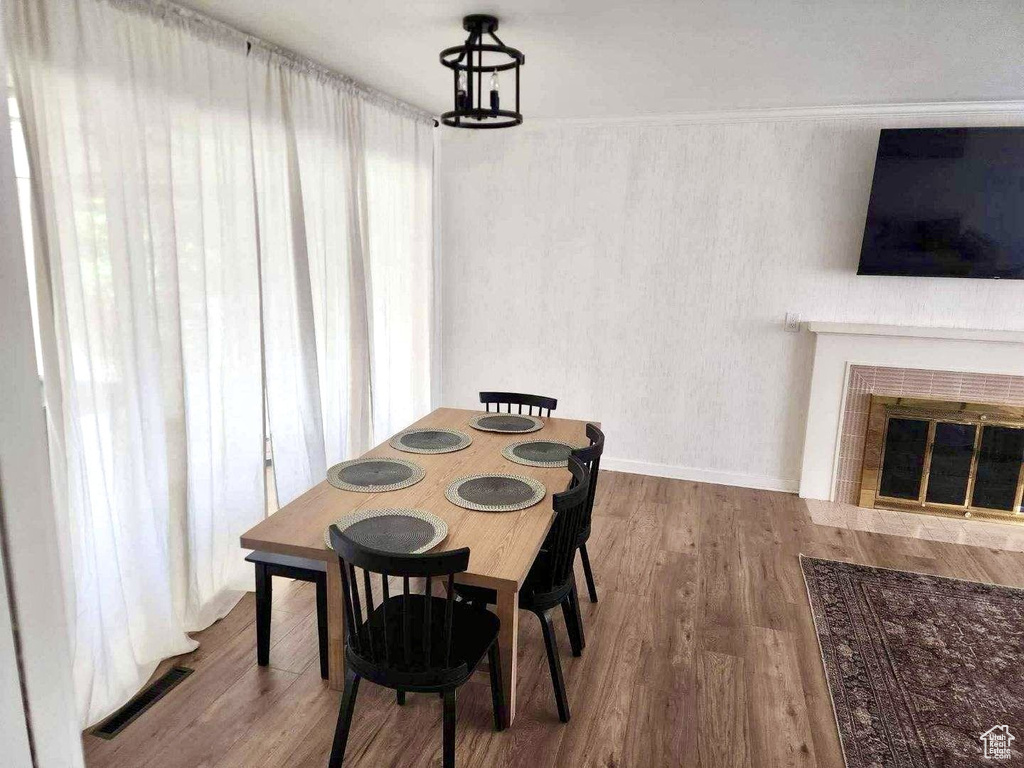 Dining space featuring wood finished floors and a tile fireplace
