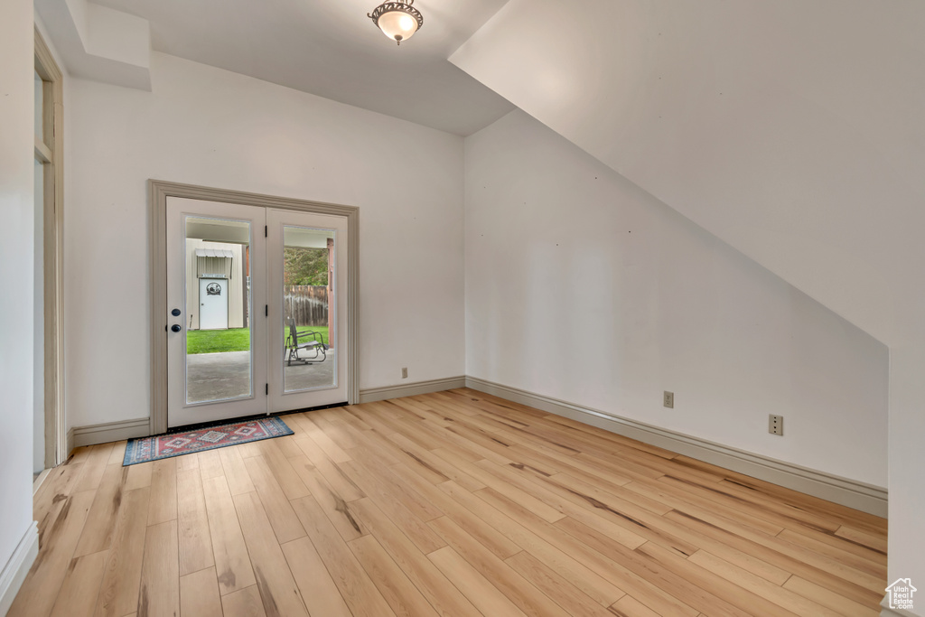Bonus room with light wood-style flooring and baseboards