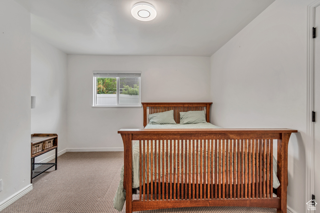 Bedroom with baseboards and carpet flooring