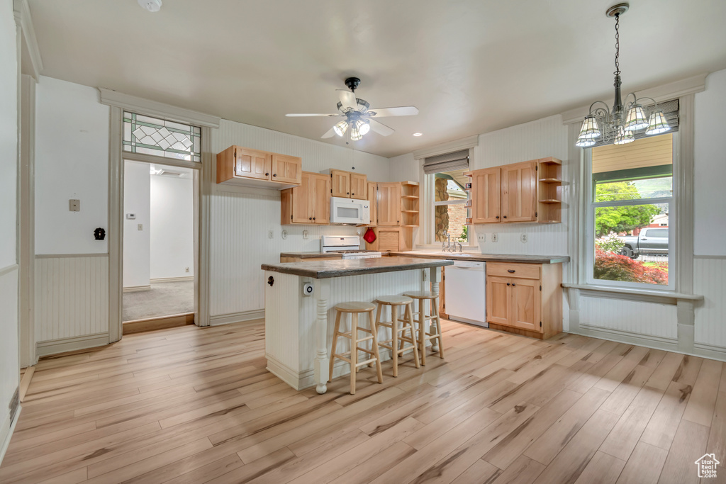 Kitchen featuring white appliances, open shelves, light wood-style floors, ceiling fan, and light brown cabinetry