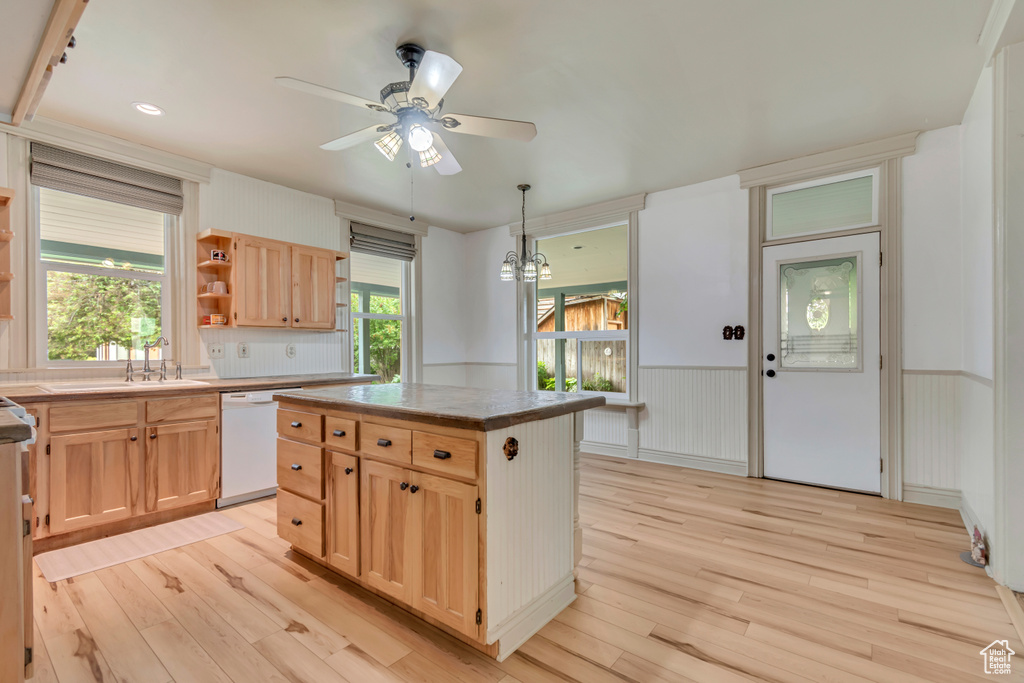 Kitchen featuring white dishwasher, a ceiling fan, light wood-style flooring, light brown cabinets, and wainscoting
