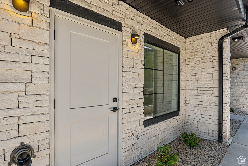 Doorway to property with stone siding
