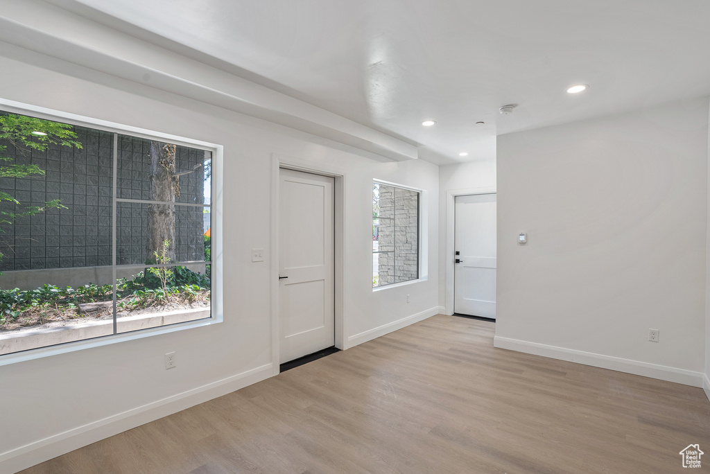 Entrance foyer featuring baseboards, wood finished floors, healthy amount of natural light, and recessed lighting