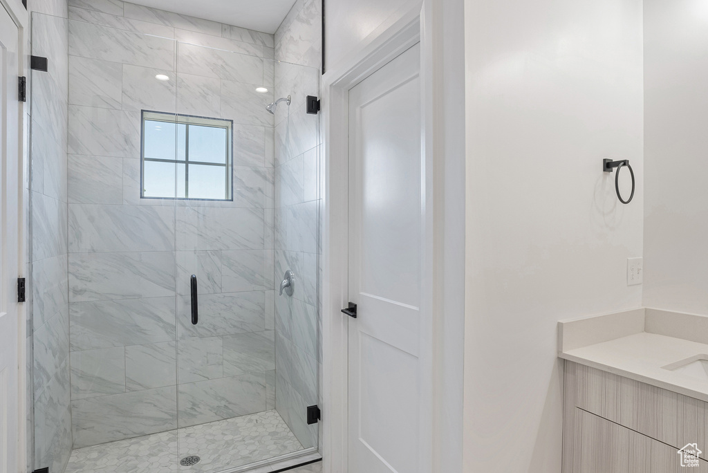 Full bath featuring a shower stall and vanity