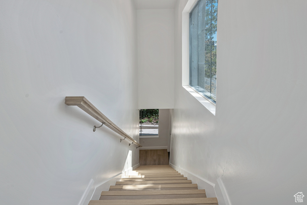 Stairs featuring wood finished floors and baseboards