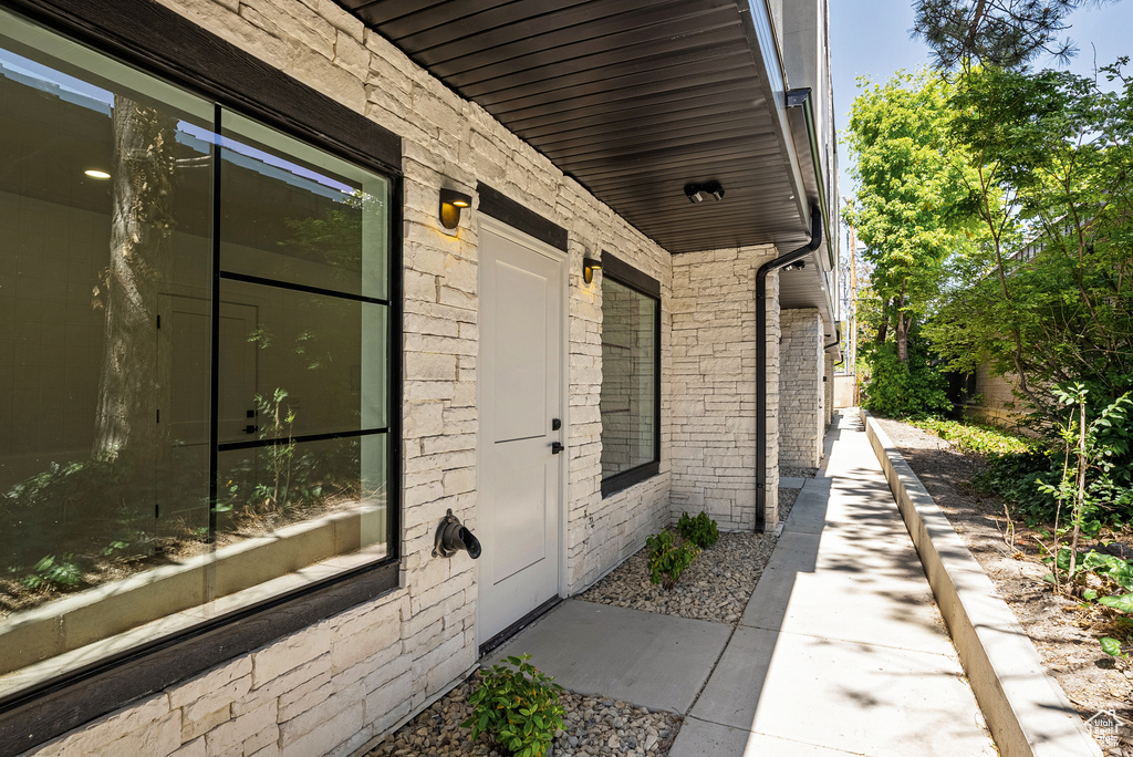 Property entrance featuring brick siding