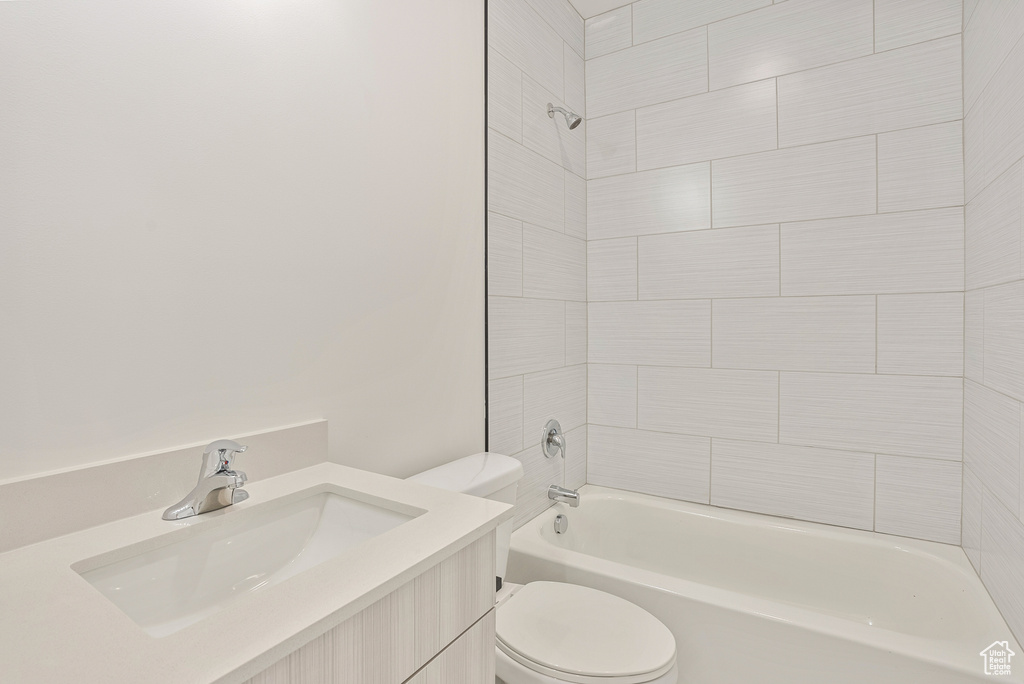 Bathroom with toilet, shower / washtub combination, and vanity