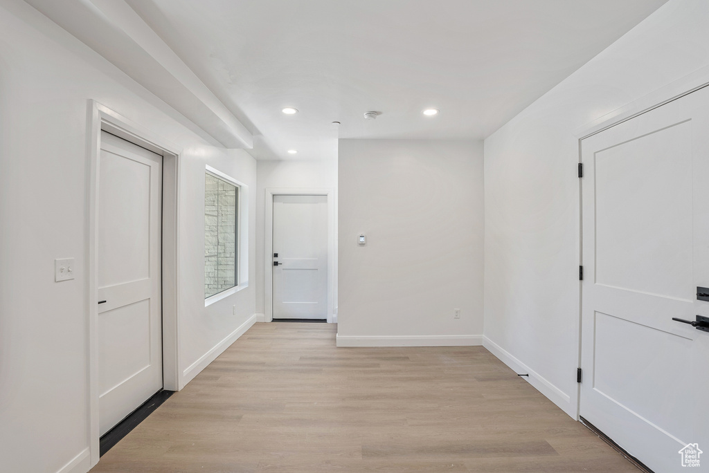 Corridor featuring baseboards, recessed lighting, and light wood-style flooring
