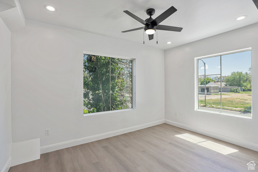 Unfurnished room with baseboards, recessed lighting, wood finished floors, and a ceiling fan