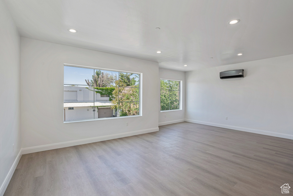 Unfurnished room featuring recessed lighting, wood finished floors, and baseboards