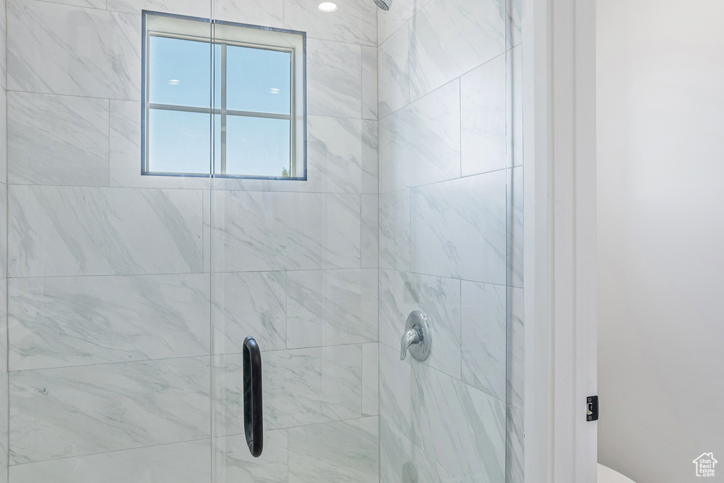 Bathroom featuring a shower stall and toilet