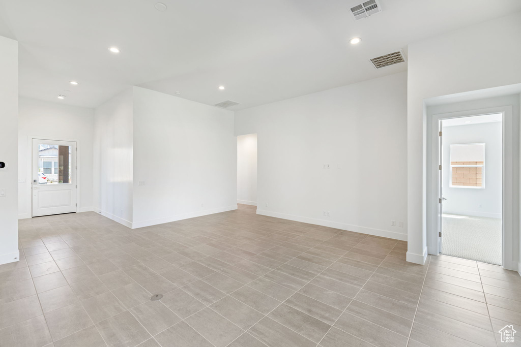 Unfurnished room with recessed lighting, light tile patterned floors, and baseboards