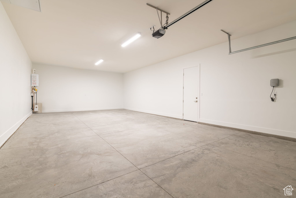 Garage with a garage door opener and baseboards