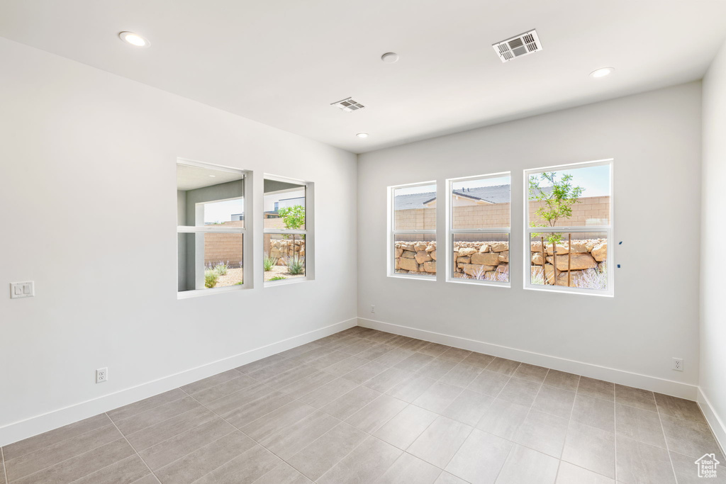 Empty room with baseboards and recessed lighting