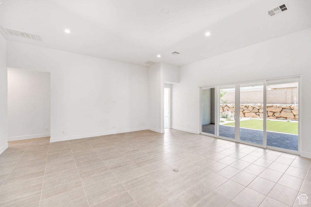 Spare room with recessed lighting, baseboards, and light tile patterned flooring