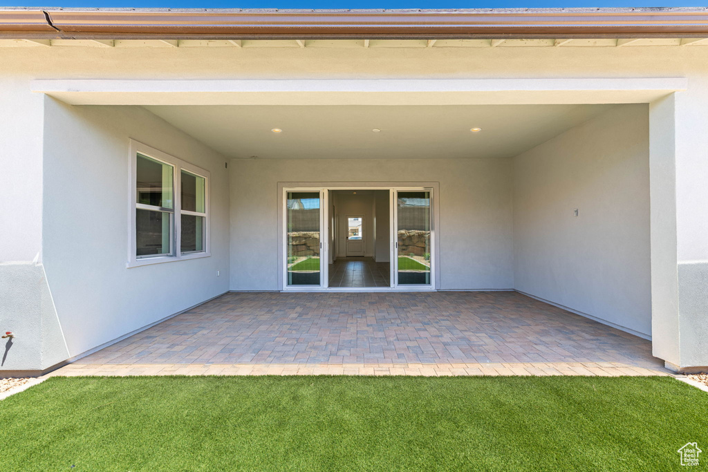 Back of property featuring stucco siding and a patio area