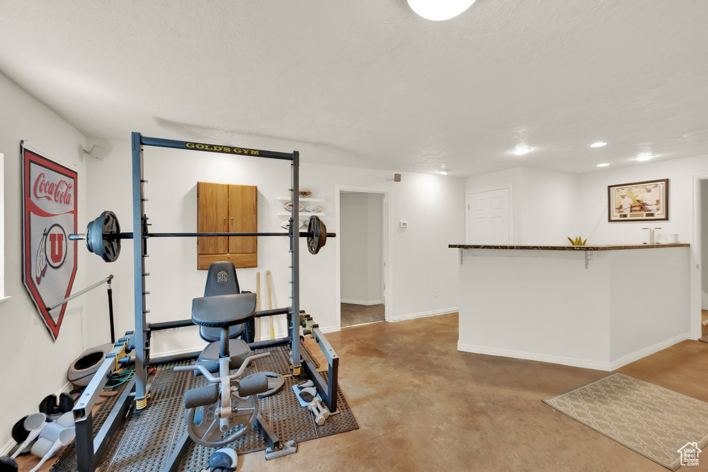 Workout area featuring baseboards and recessed lighting