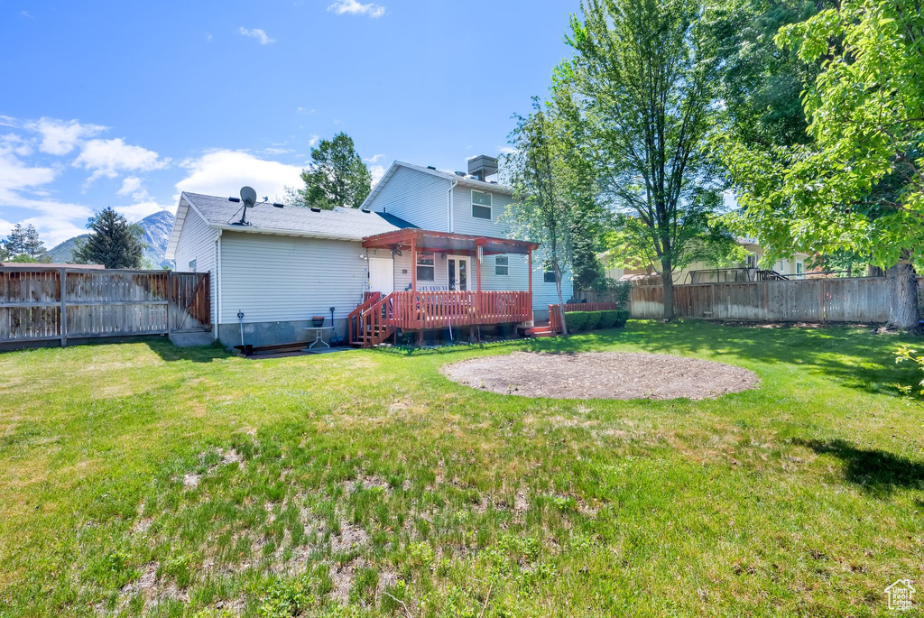 Back of property featuring a wooden deck