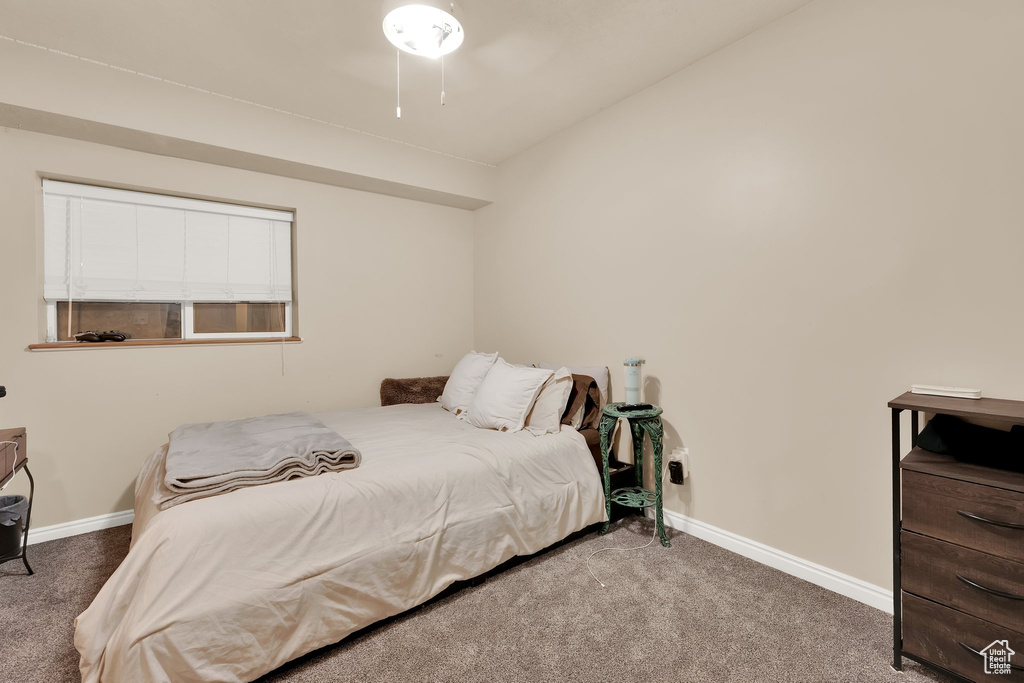Carpeted bedroom featuring baseboards