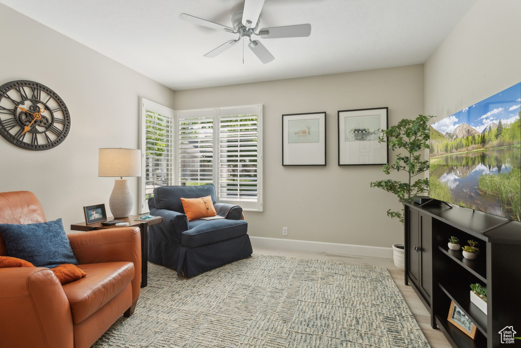 Sitting room featuring ceiling fan and baseboards