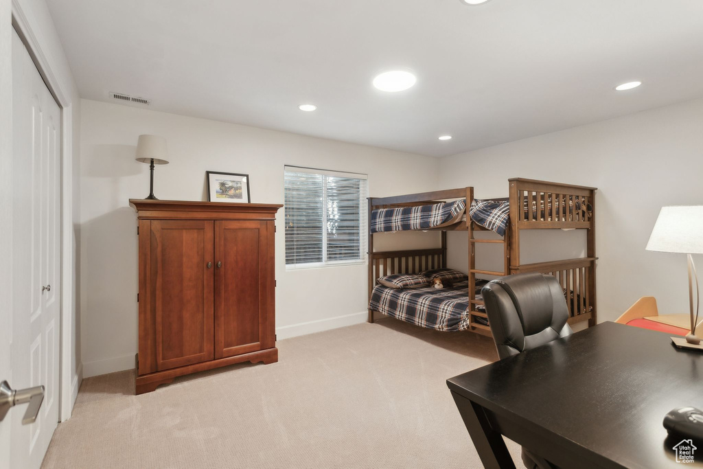Bedroom featuring light carpet, baseboards, and recessed lighting