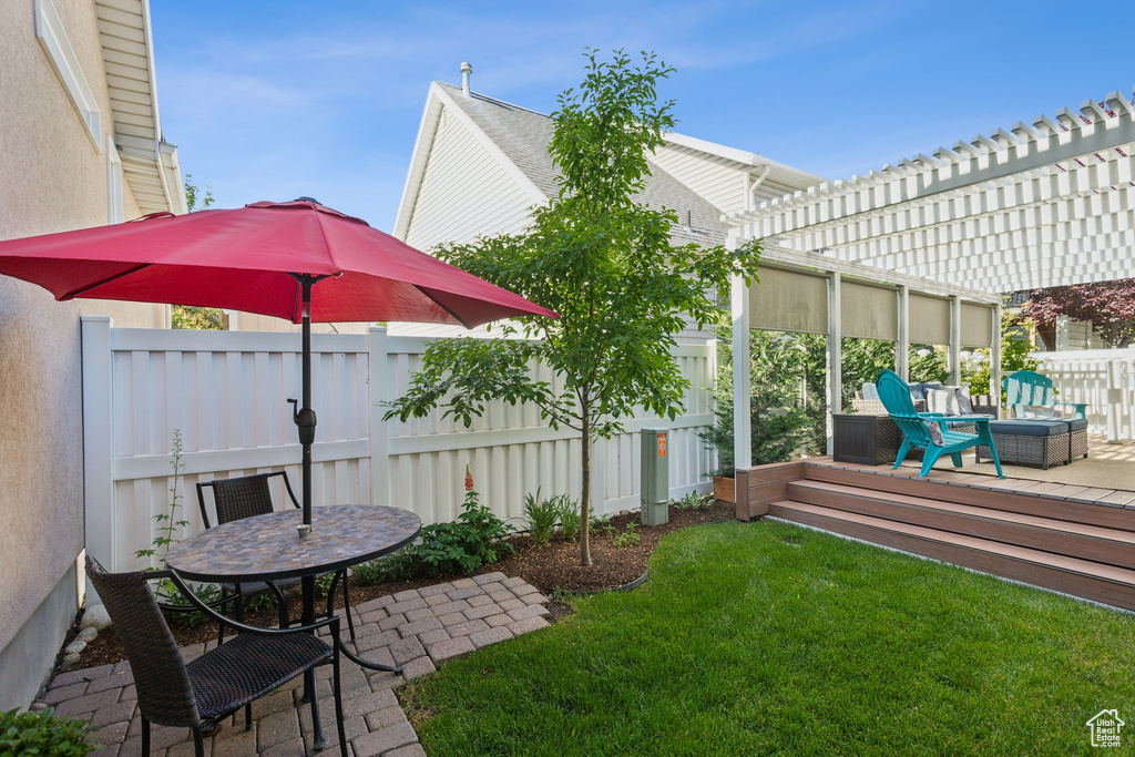 View of yard featuring a pergola, a patio area, and a wooden deck